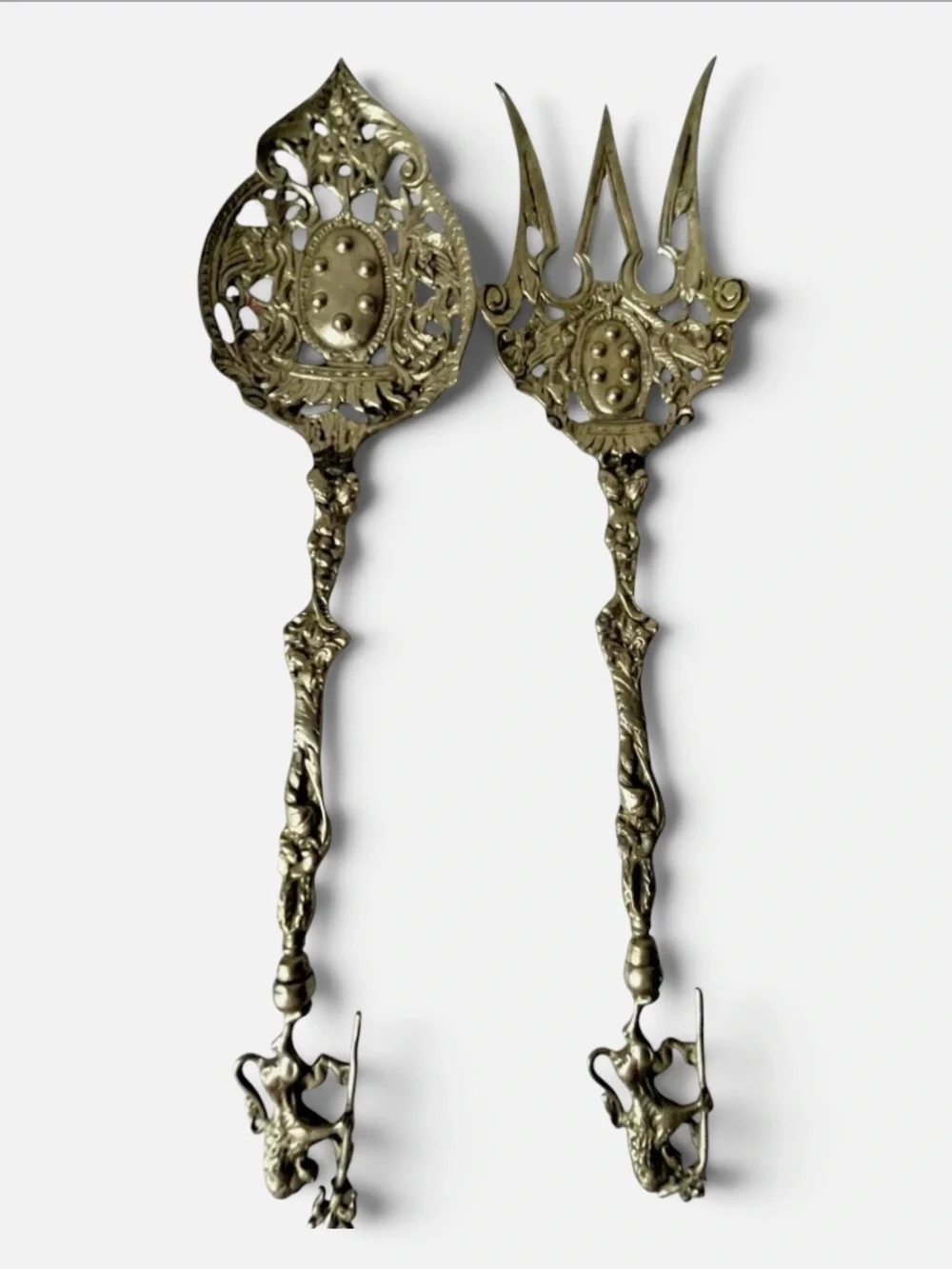vintage Italian serving utensils are an ornate brass fork and spoon set